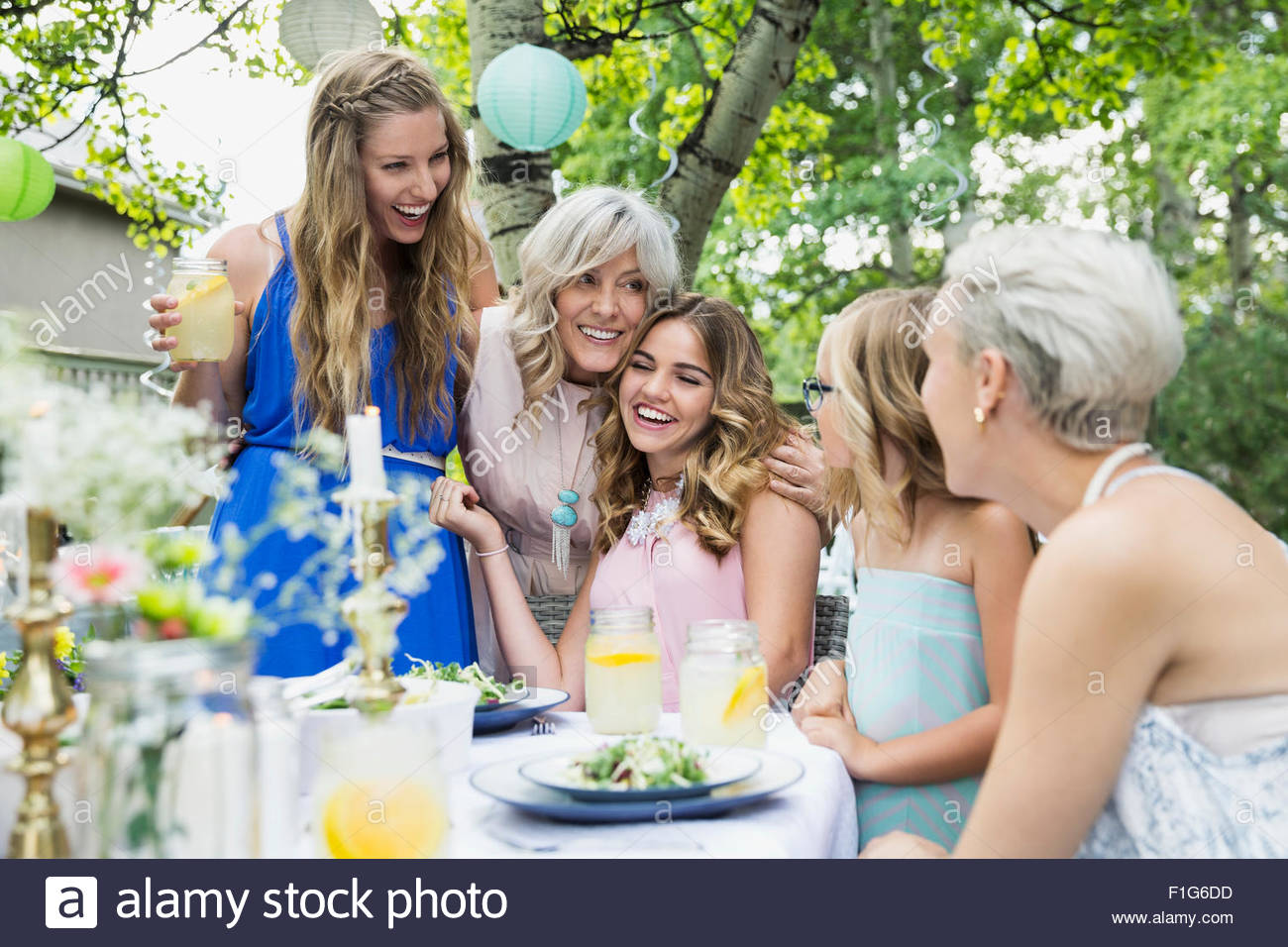 Smiling women family enjoying garden party lunch Stock Photo