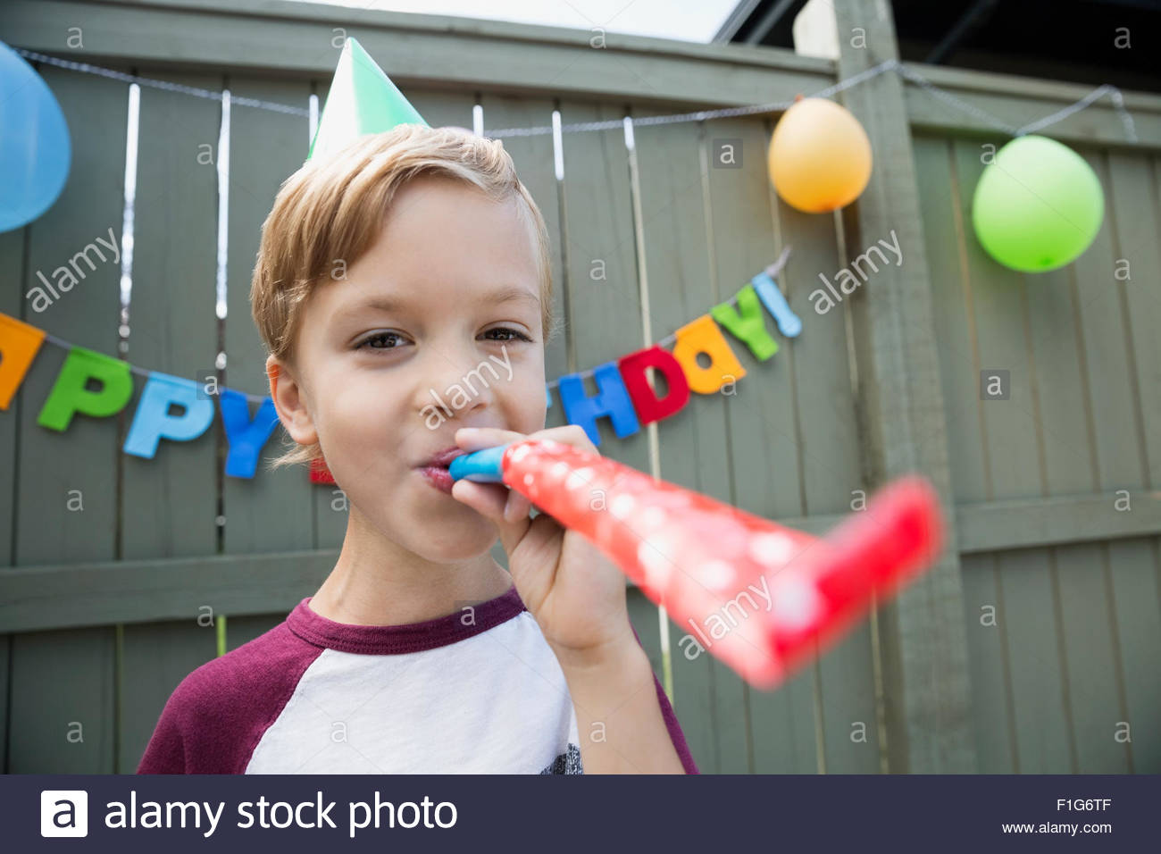 Boy blowing party blower hires stock photography and images Alamy