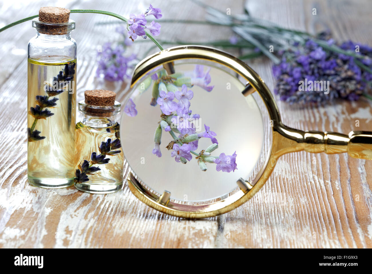 White heart and lavender oil on wooden table Stock Photo