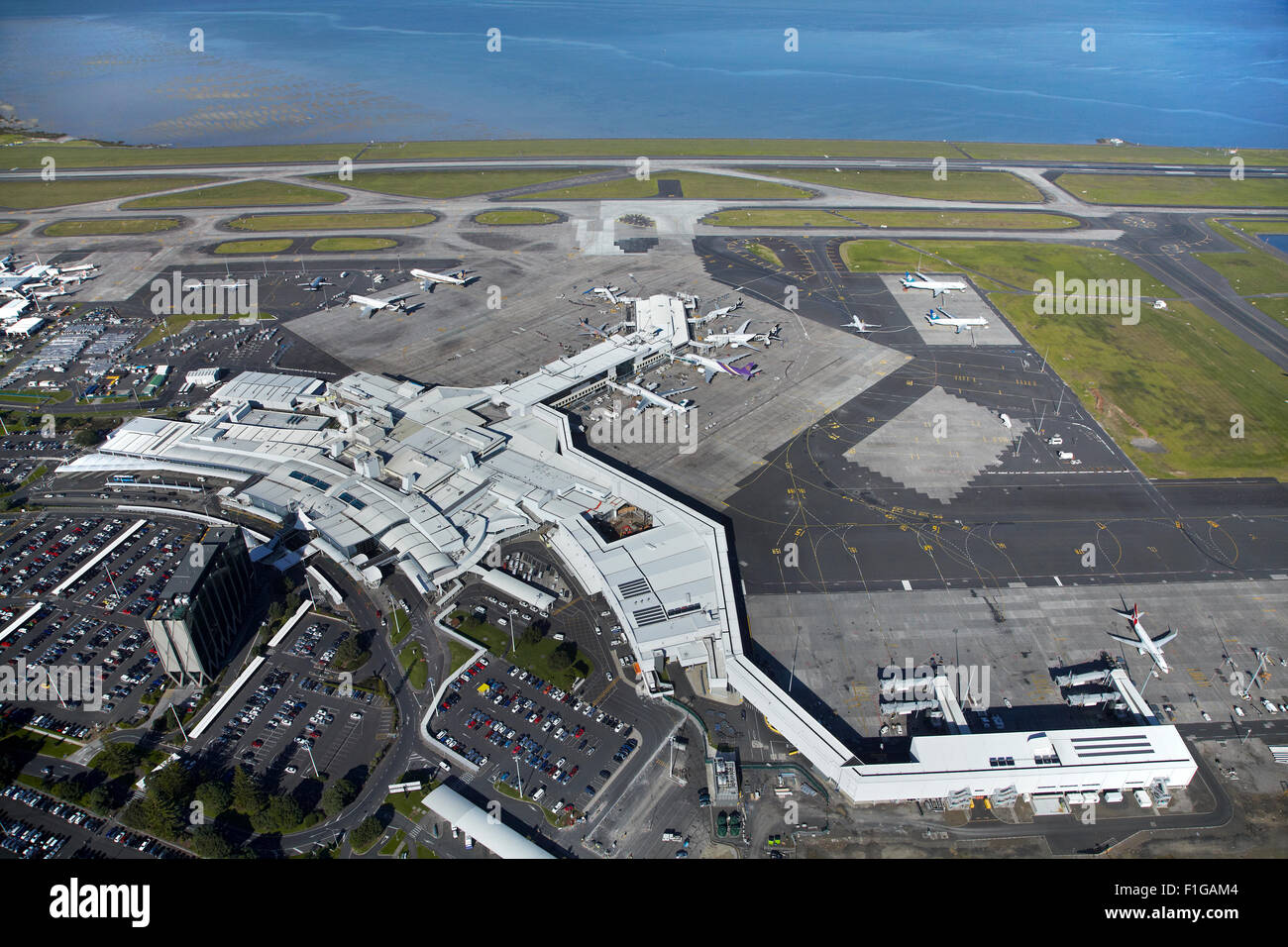 Auckland Airport International Terminal and Manukau Harbour, North Island, New Zealand - aerial Stock Photo