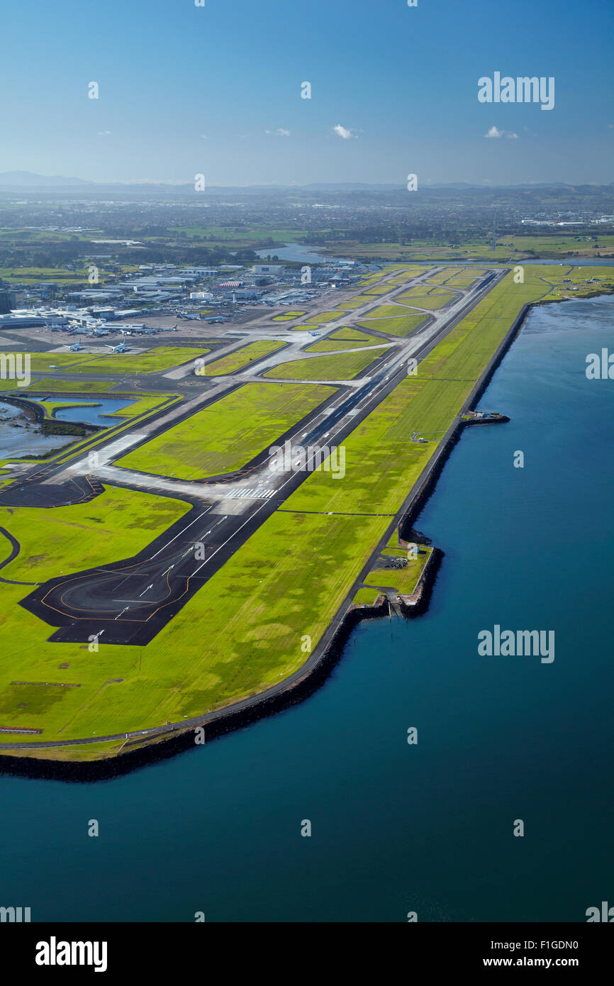 Runway at Auckland Airport, and Manukau Harbour, North Island, New Zealand - aerial Stock Photo