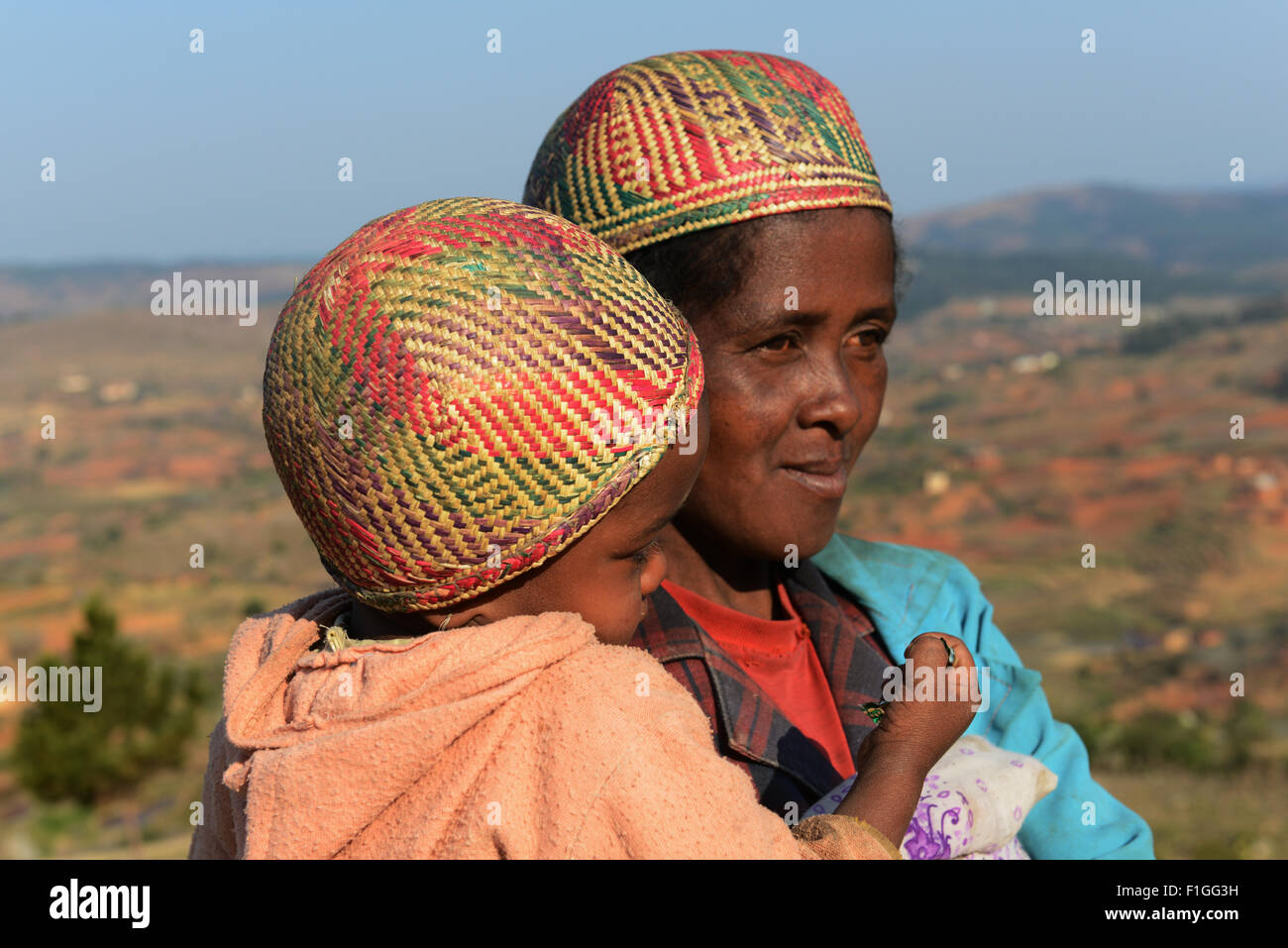 A betsileo woman with her child wearing a traditional betsileo hat. Stock Photo