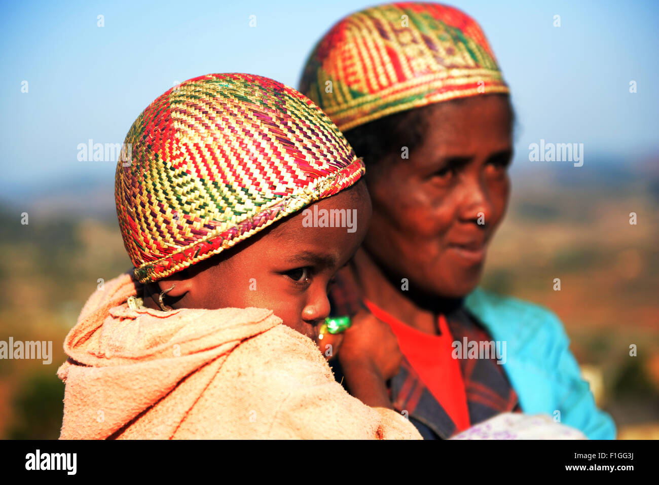 A betsileo woman with her child wearing a traditional betsileo hat. Stock Photo