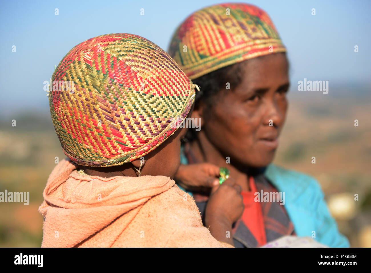 A betsileo woman with her child wearing a traditional betsileo hat. Stock Photo
