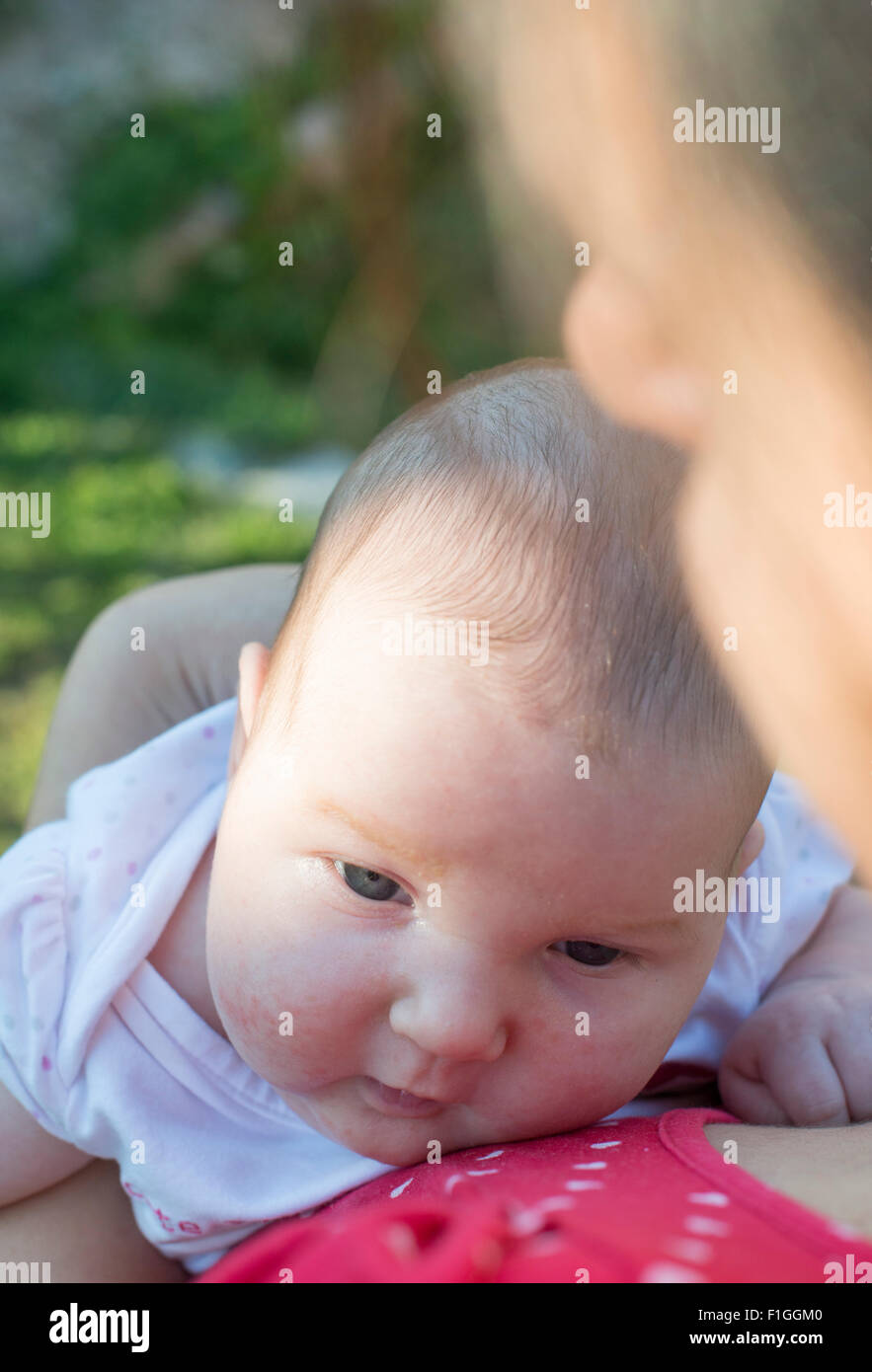 Baby in his mother's arms. Close up Stock Photo