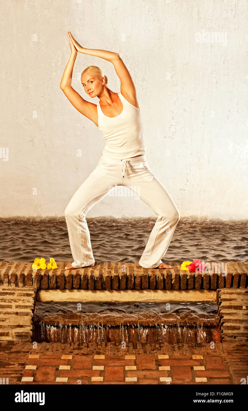 Beautiful young woman doing yoga exercise Stock Photo - Alamy