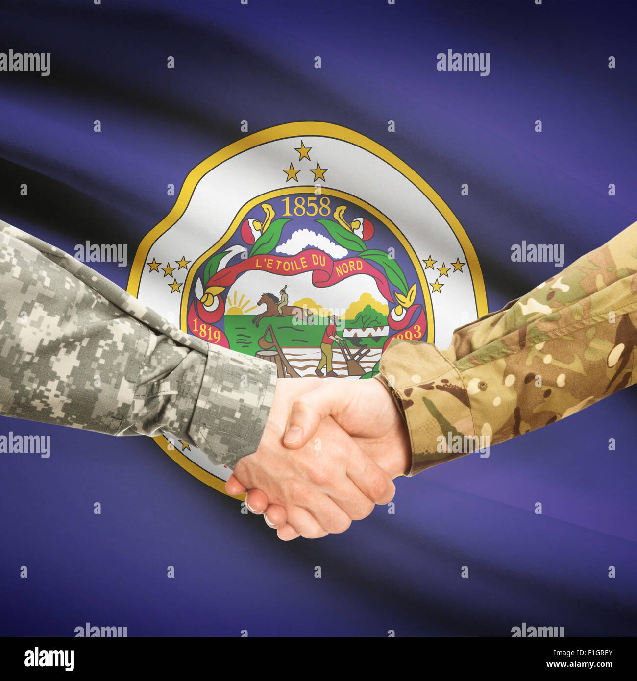 Soldiers handshake and US state flag - Minnesota Stock Photo