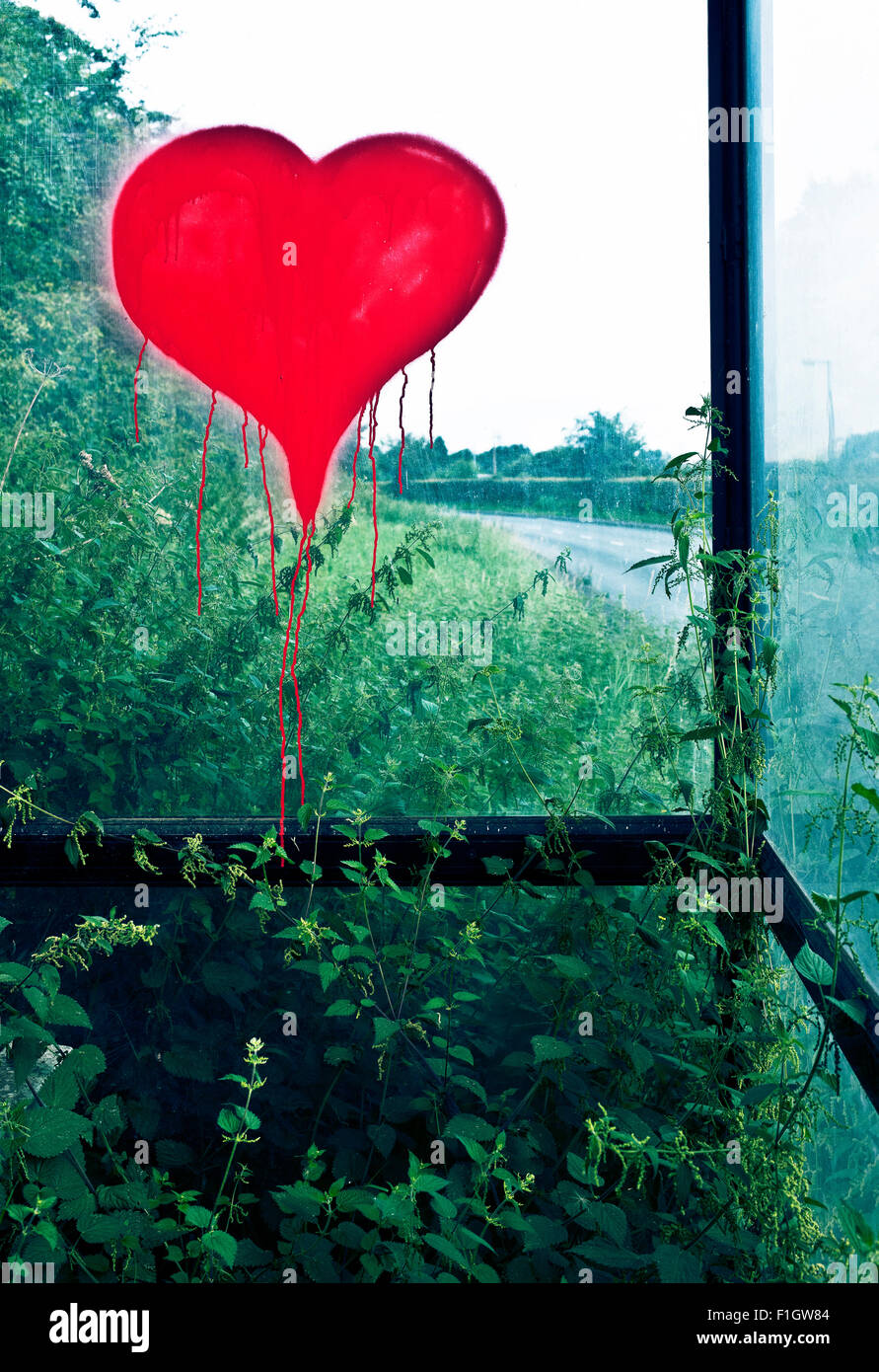 heart tag sprayed on country bus stop glass Stock Photo