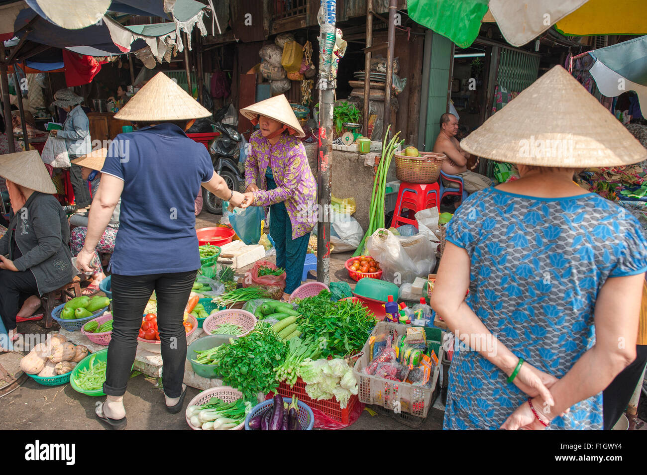 Binh tay market, Vietnamese women shop for vegetables on sidewalk stalls in Binh Tay market in the Cholon area of Saigon, Ho Chi Minh City, Vietnam. Stock Photo