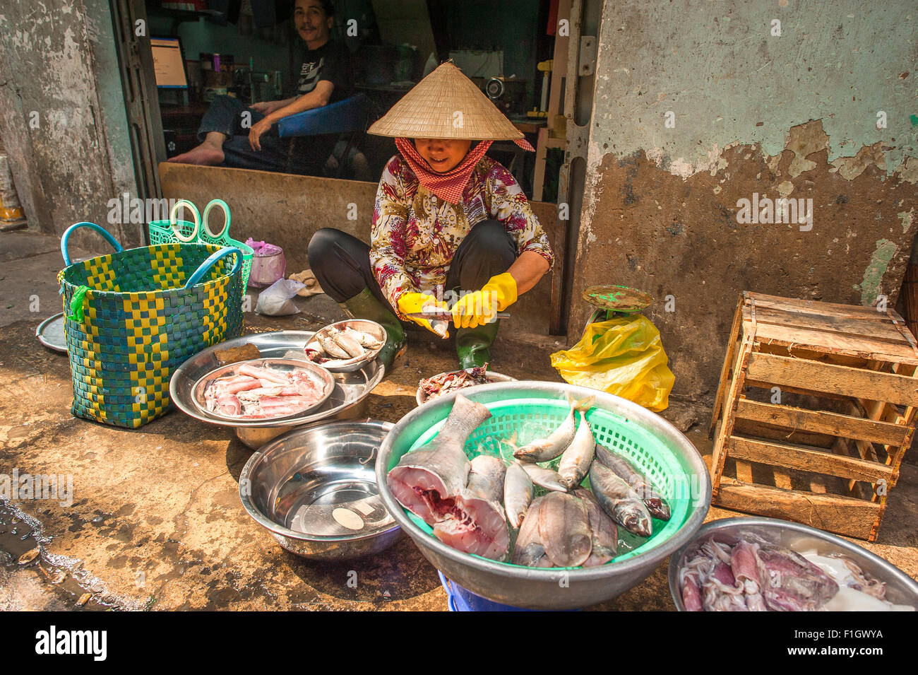 Binh Tay market Cholon, a Vietnamese woman offers fish for sale on a sidewalk near the Binh Tay market in Cholon district, Saigon, Vietnam. Stock Photo