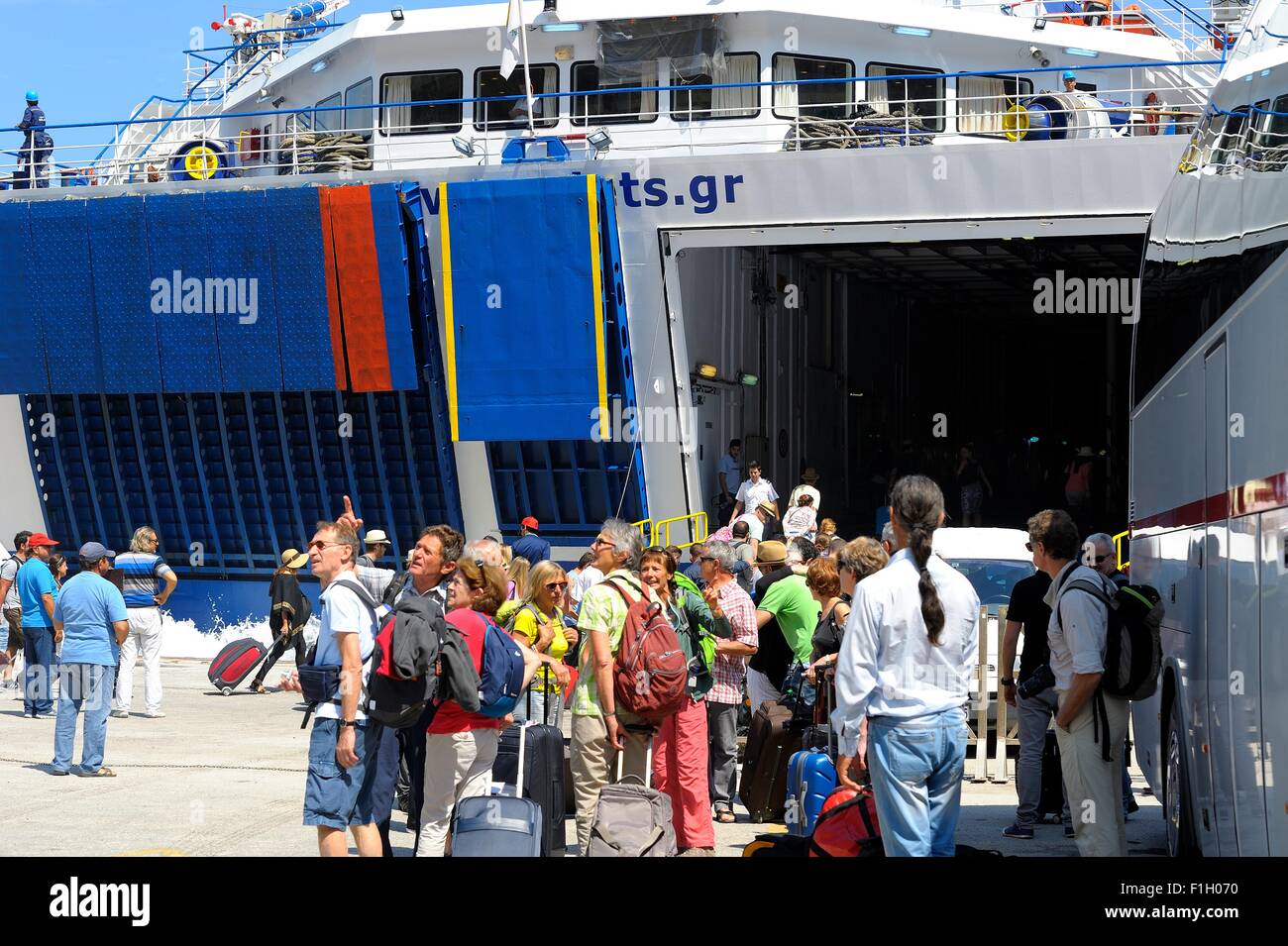 Ferry passengers arriving in the port of Ormos Athinios Santorini Greece Stock Photo