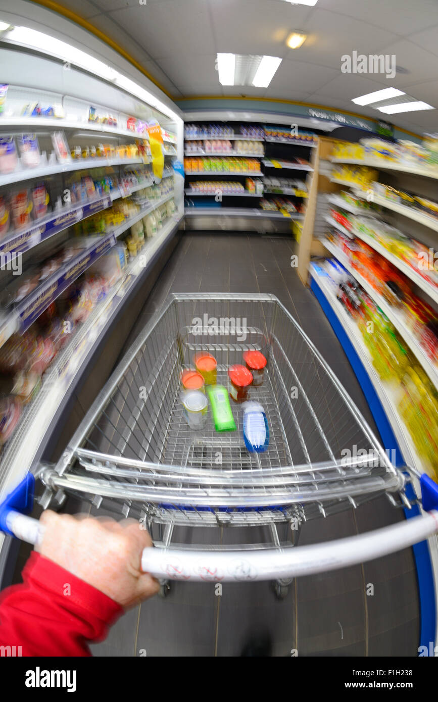 customer pushing shopping trolley at speed in supermarket Stock Photo