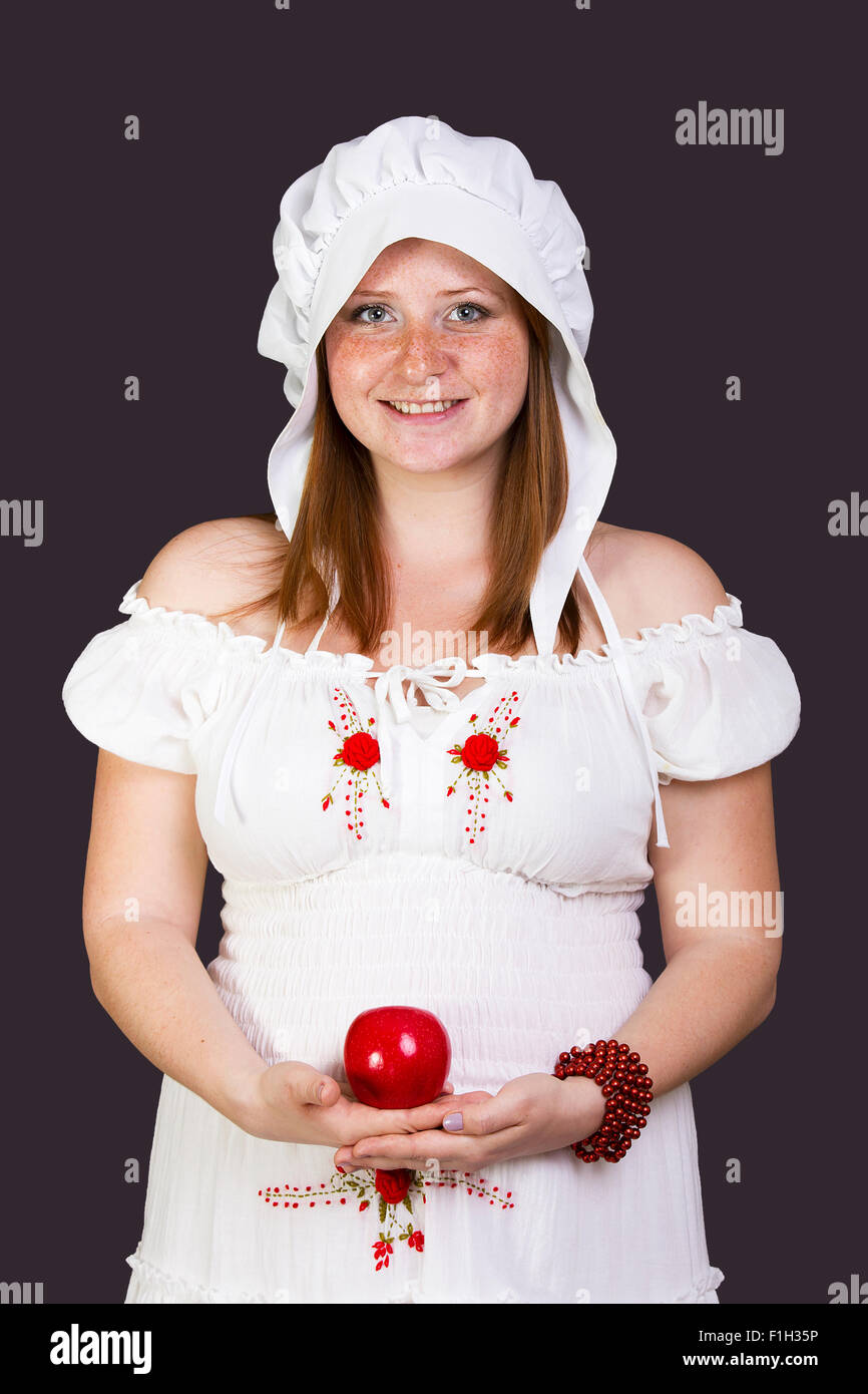 Redhead beauty with an apple in her hand Stock Photo