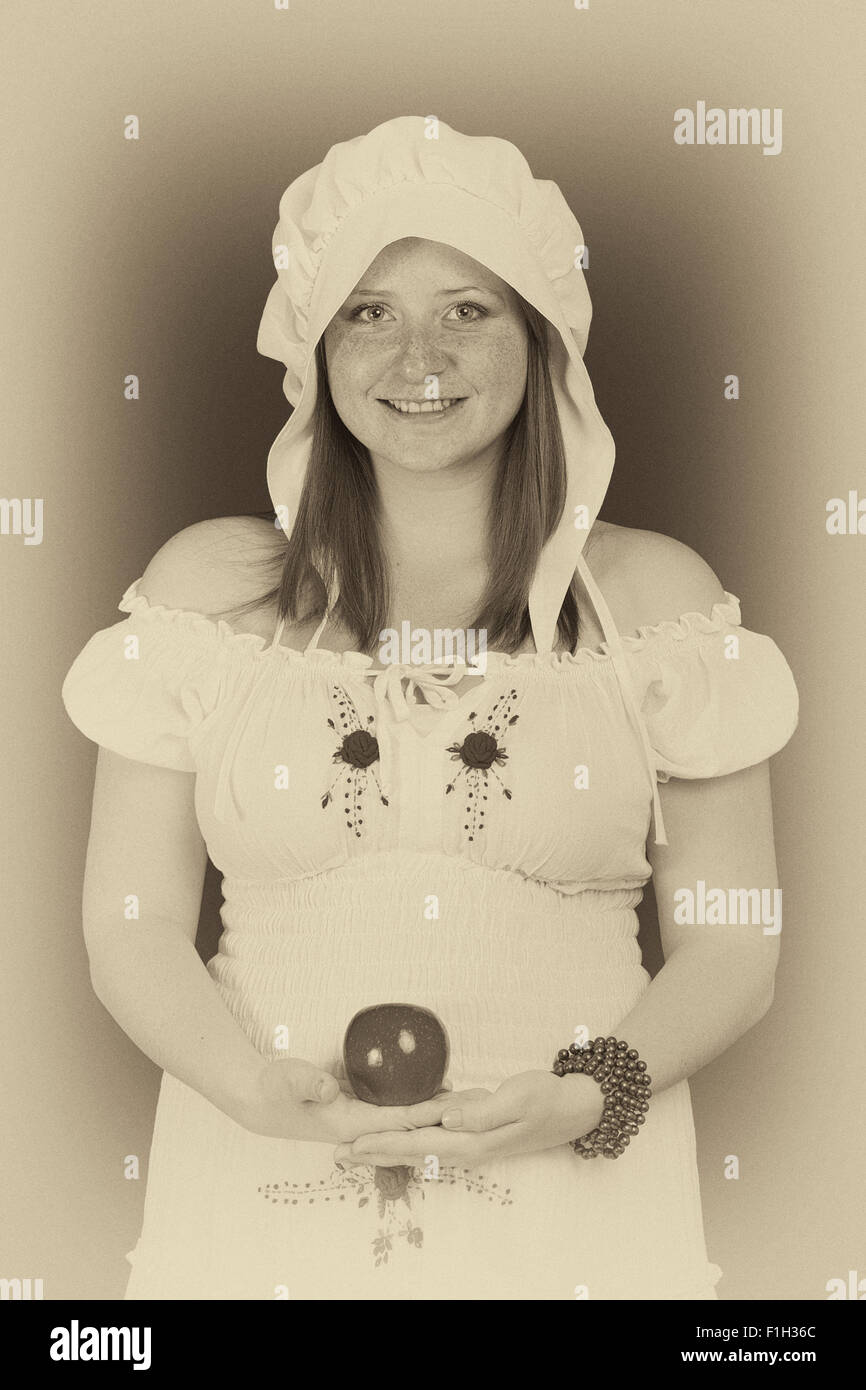 Redhead beauty with an apple in her hand Stock Photo