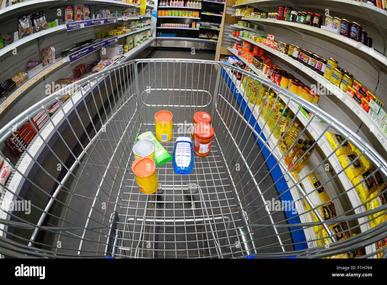 man shopping using trolley in supermarket Stock Photo