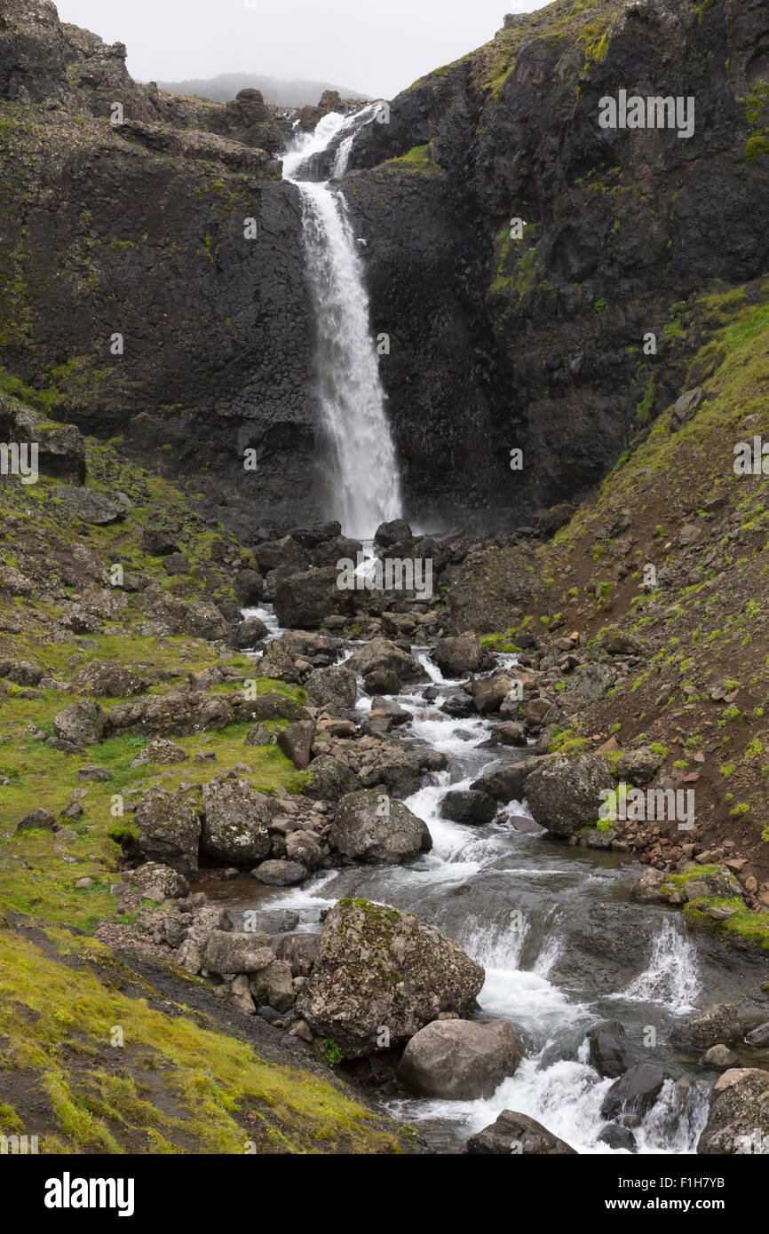 A waterfall that discharges into Álftafjörður lagoon, East Iceland Stock Photo