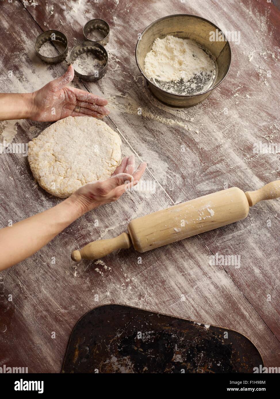 Overhead view of womans hands shaping scone dough Stock Photo
