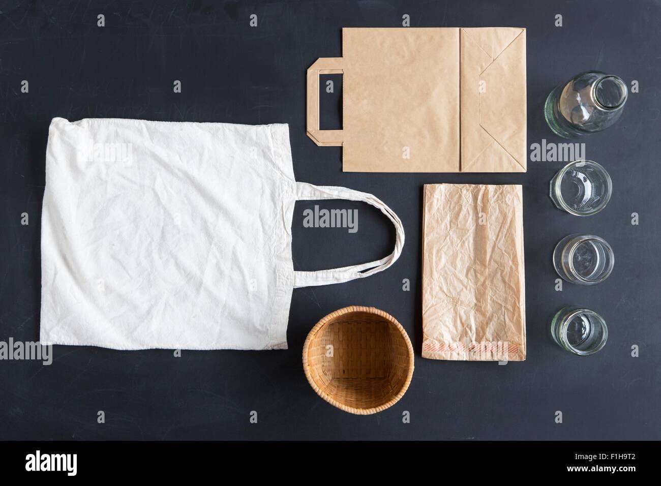 Overhead still life of reusable and paper bags and glasses Stock Photo