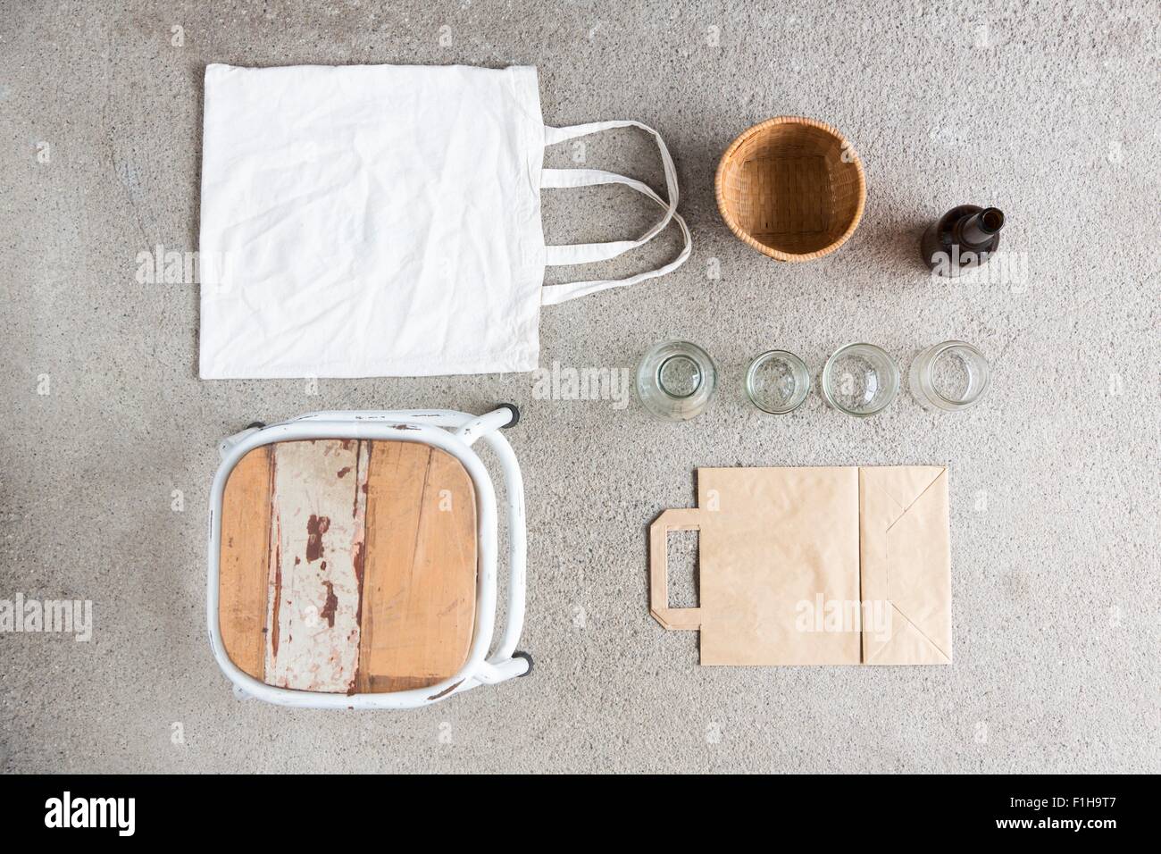 Overhead still life of stool, reusable shopping bag and recyclable paper and bottles Stock Photo