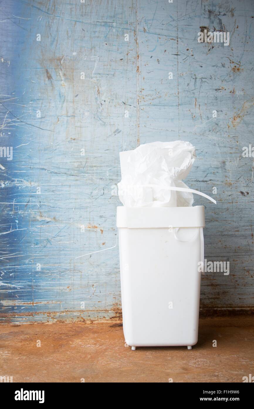 Bin full of paper for recycling in front of wall Stock Photo - Alamy