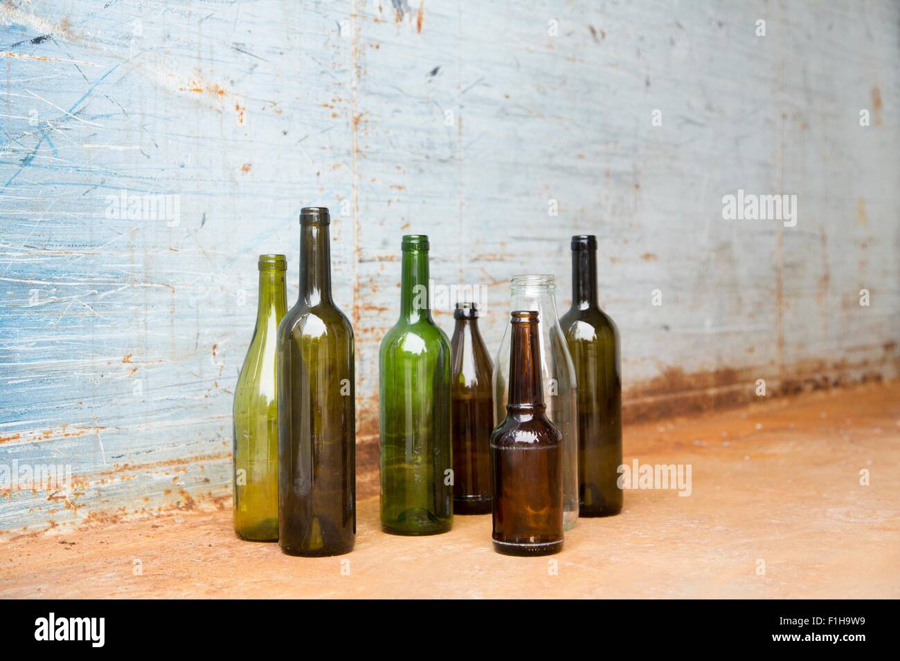 Empty bottles for recycling in front of wall Stock Photo