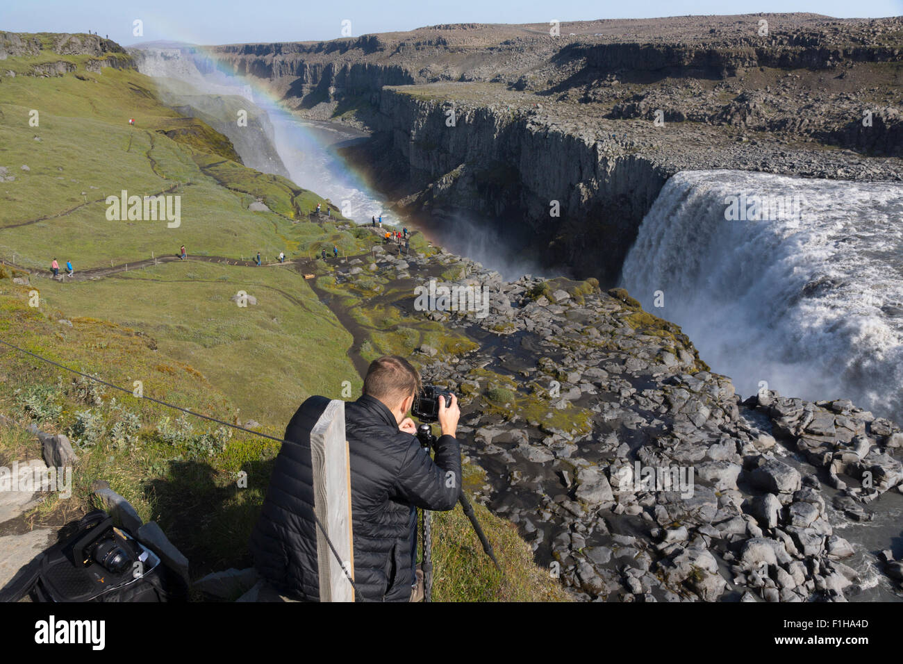 A professional photographer taking a picture of Dettifoss waterfall, in the Jökulsárgljúfur canyon, Vatnajökull National Park, northeast Iceland Stock Photo