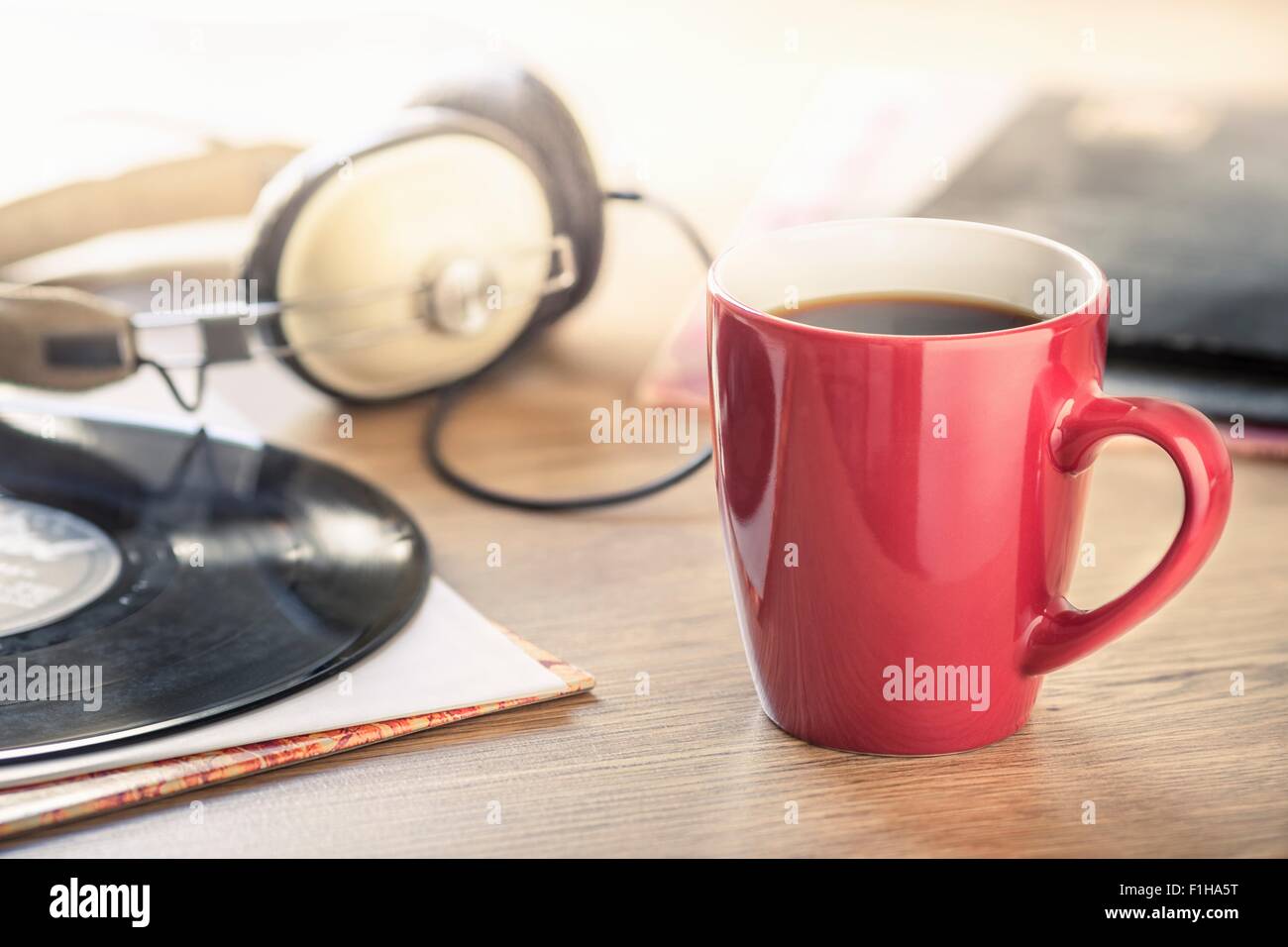 Still life of black coffee, headphones and vinyl record Stock Photo