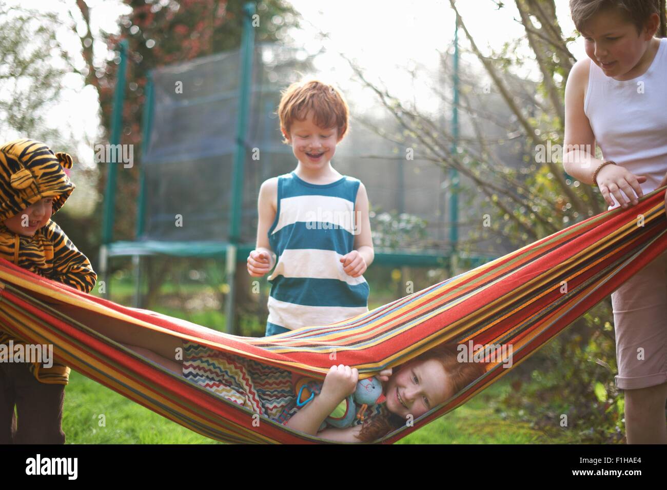 Young children playing in garden Stock Photo
