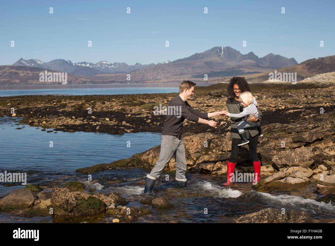 Mother holding son by Loch Eishort, Isle of Skye, Hebrides, Scotland Stock Photo