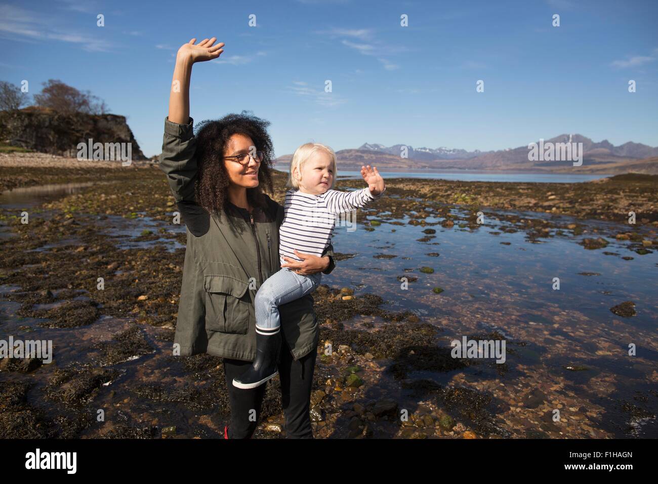 Mother and son waving, Loch Eishort, Isle of Skye, Hebrides, Scotland Stock Photo