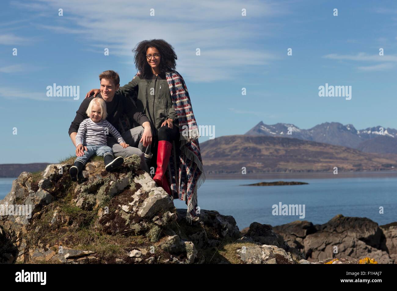 Family on rocks, Loch Eishort, Isle of Skye, Scotland Stock Photo