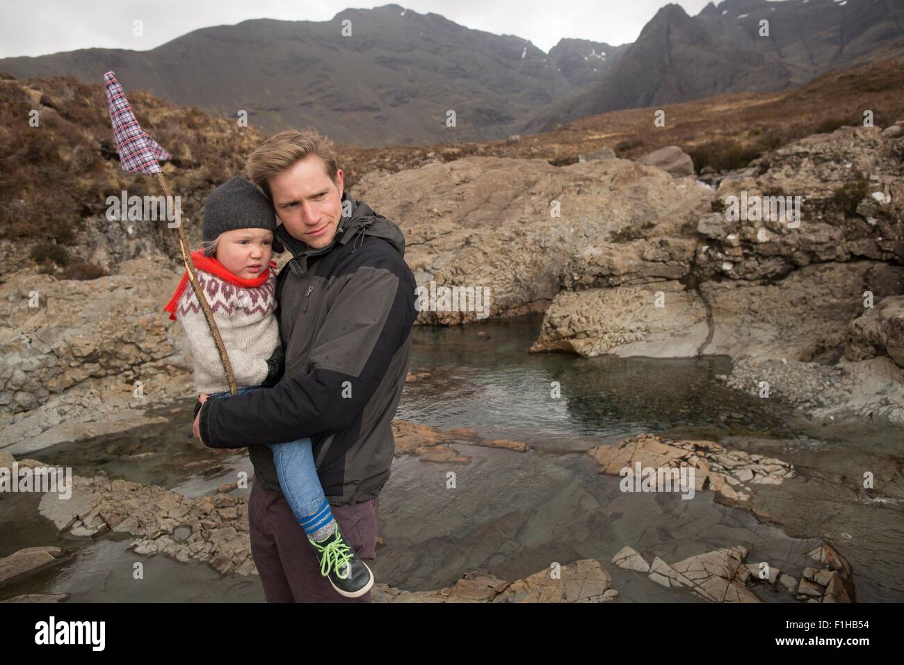 Father holding son, Fairy Pools, Isle of Skye, Hebrides, Scotland Stock Photo