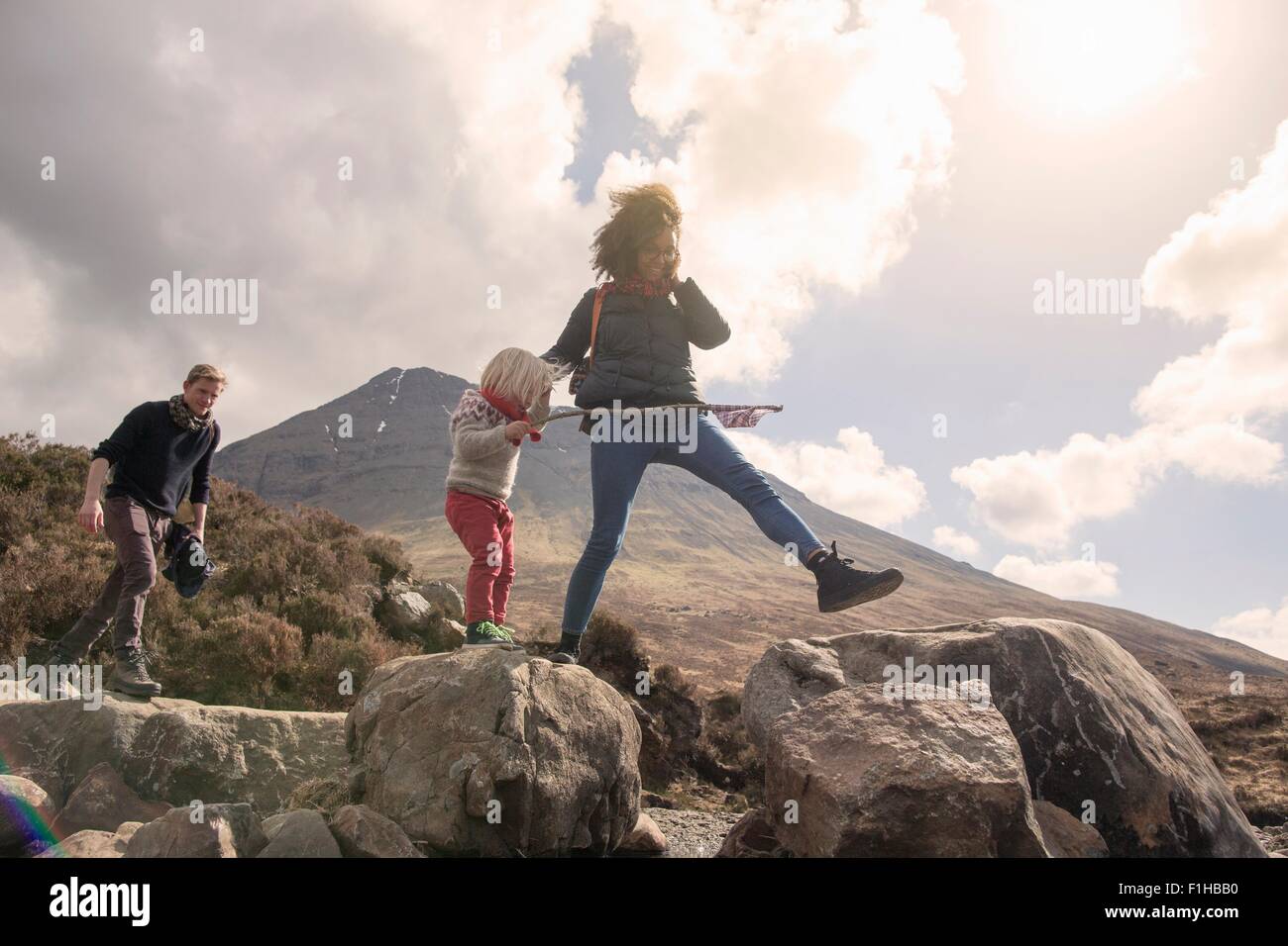Family walking over boulders, Fair Pools, Isle of Skye, Hebrides, Scotland Stock Photo