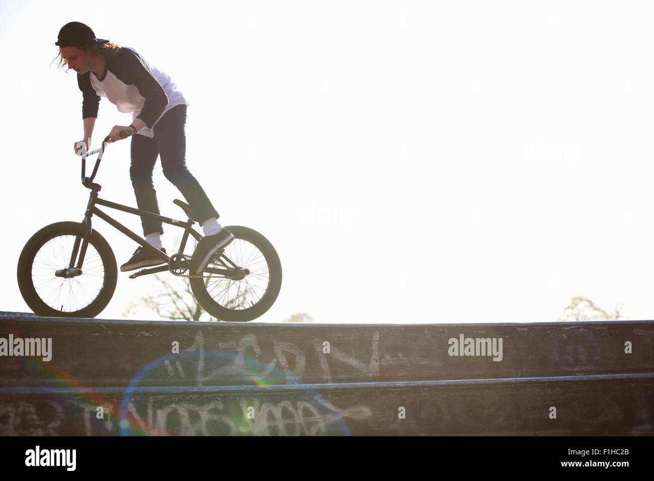Young man doing stunt on bmx at skatepark Stock Photo