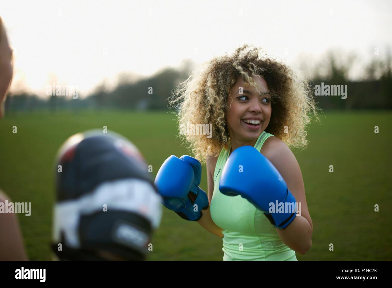 Two women exercising with boxing gloves in the park Stock Photo