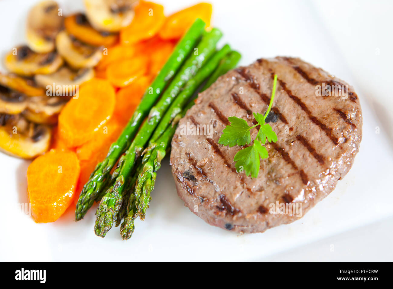 Delicious truffled beef burger with vegetables in a plate Stock Photo