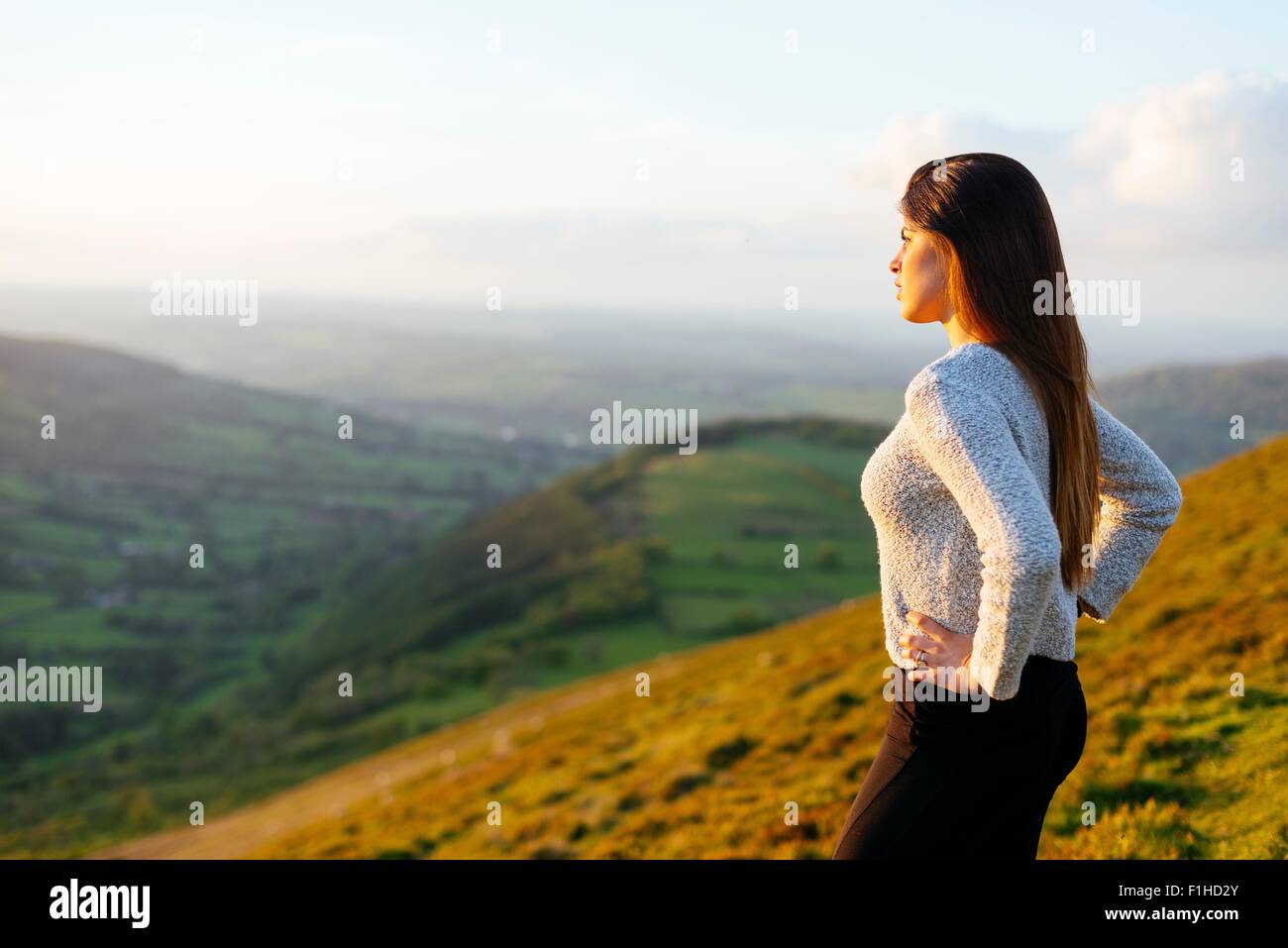 Rear view of young woman looking out over Glyn Collwn valley, Brecon Beacons, Powys, Wales Stock Photo