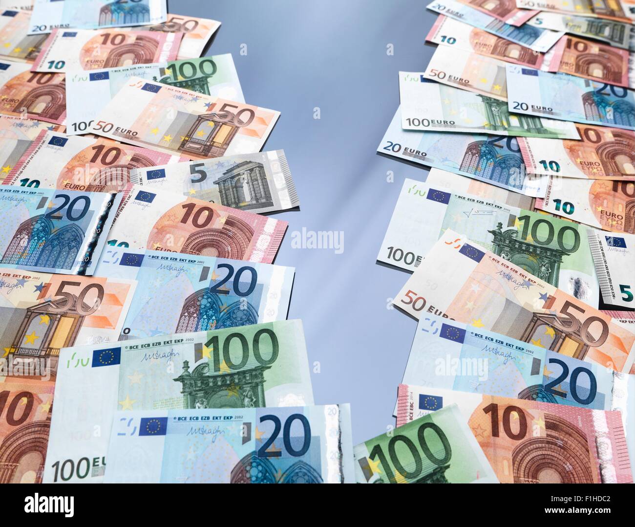 Euro currency notes split into two piles Stock Photo