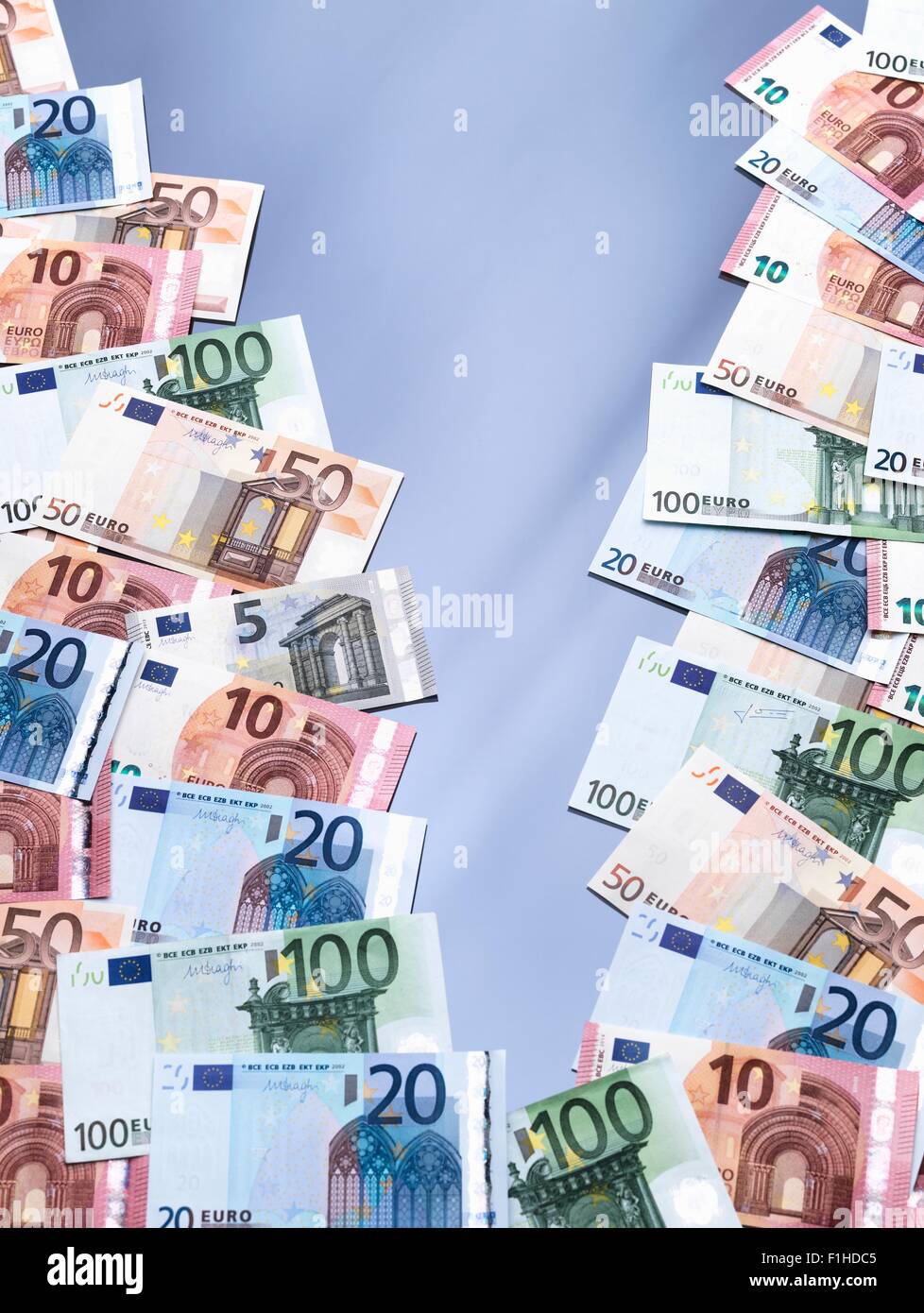 Euro currency notes split into two piles Stock Photo