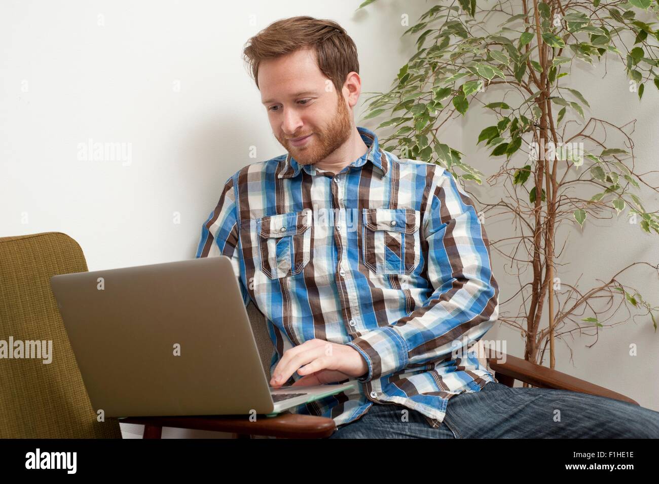 Male customer typing on laptop in style cafe Stock Photo