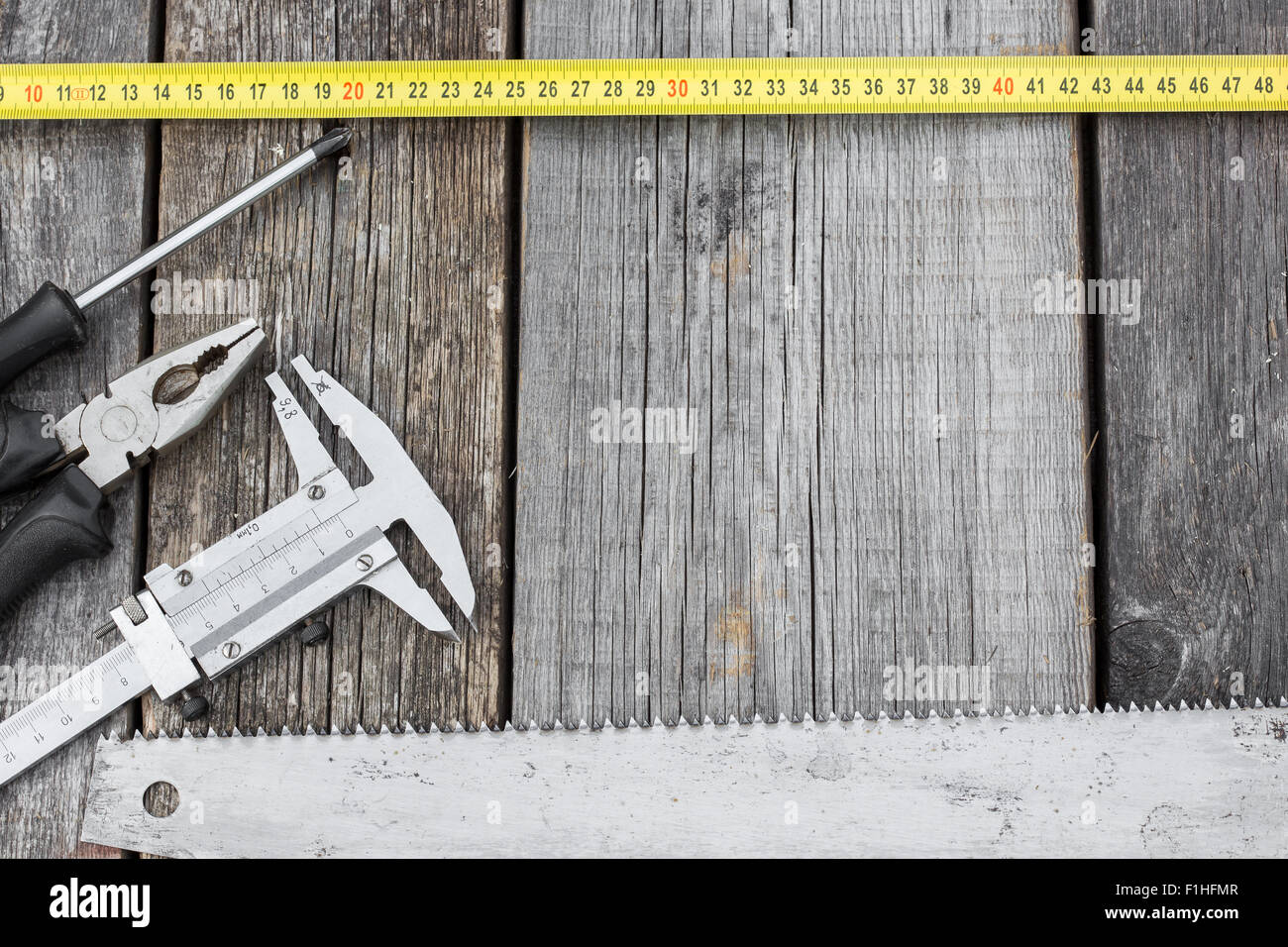 Different construction equipment on a wooden background with copy space ...
