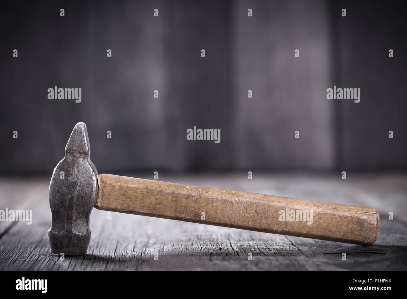 Hammer on a wooden background Stock Photo