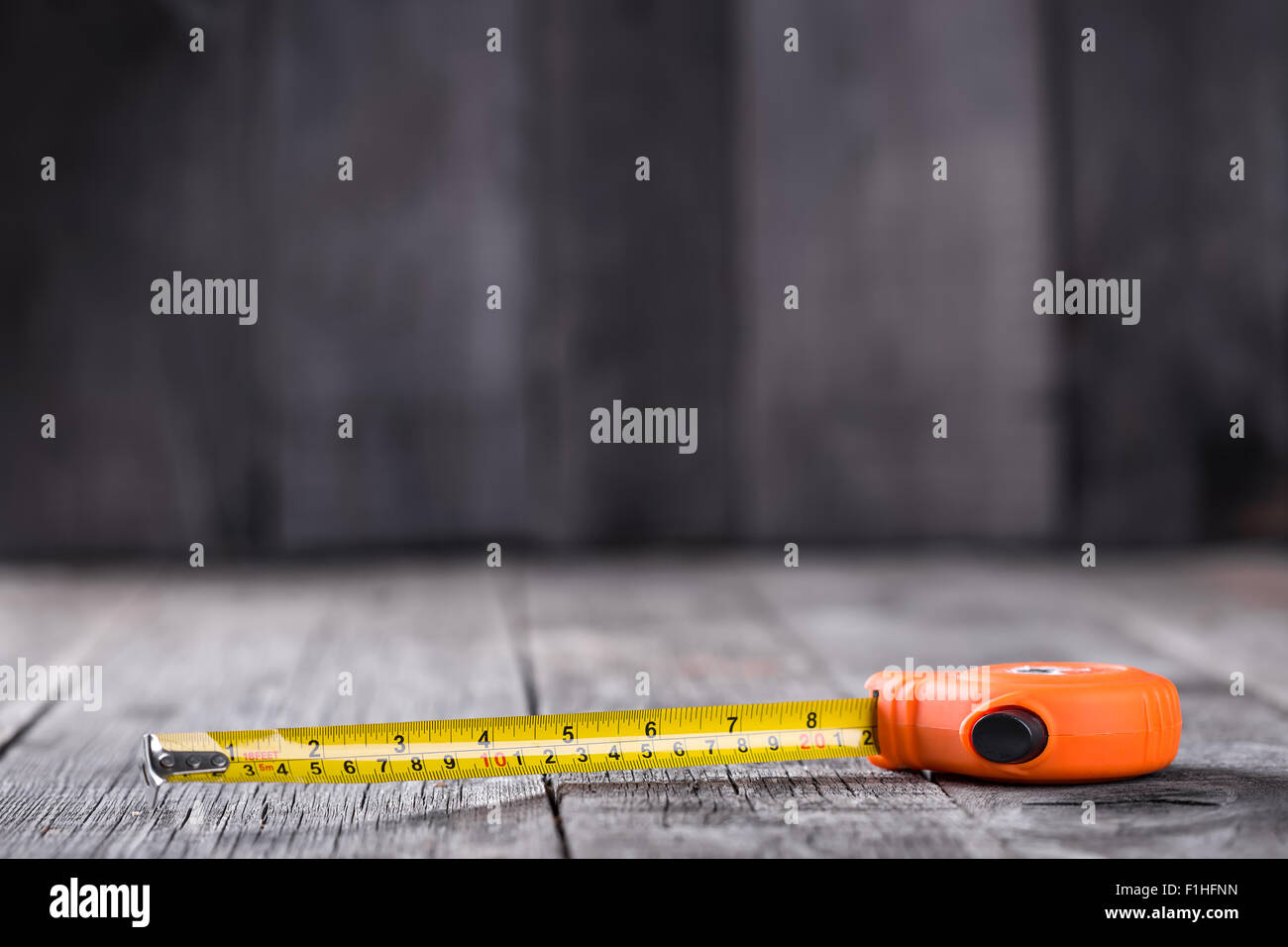 Measuring tape on a wooden board with copyspace Stock Photo
