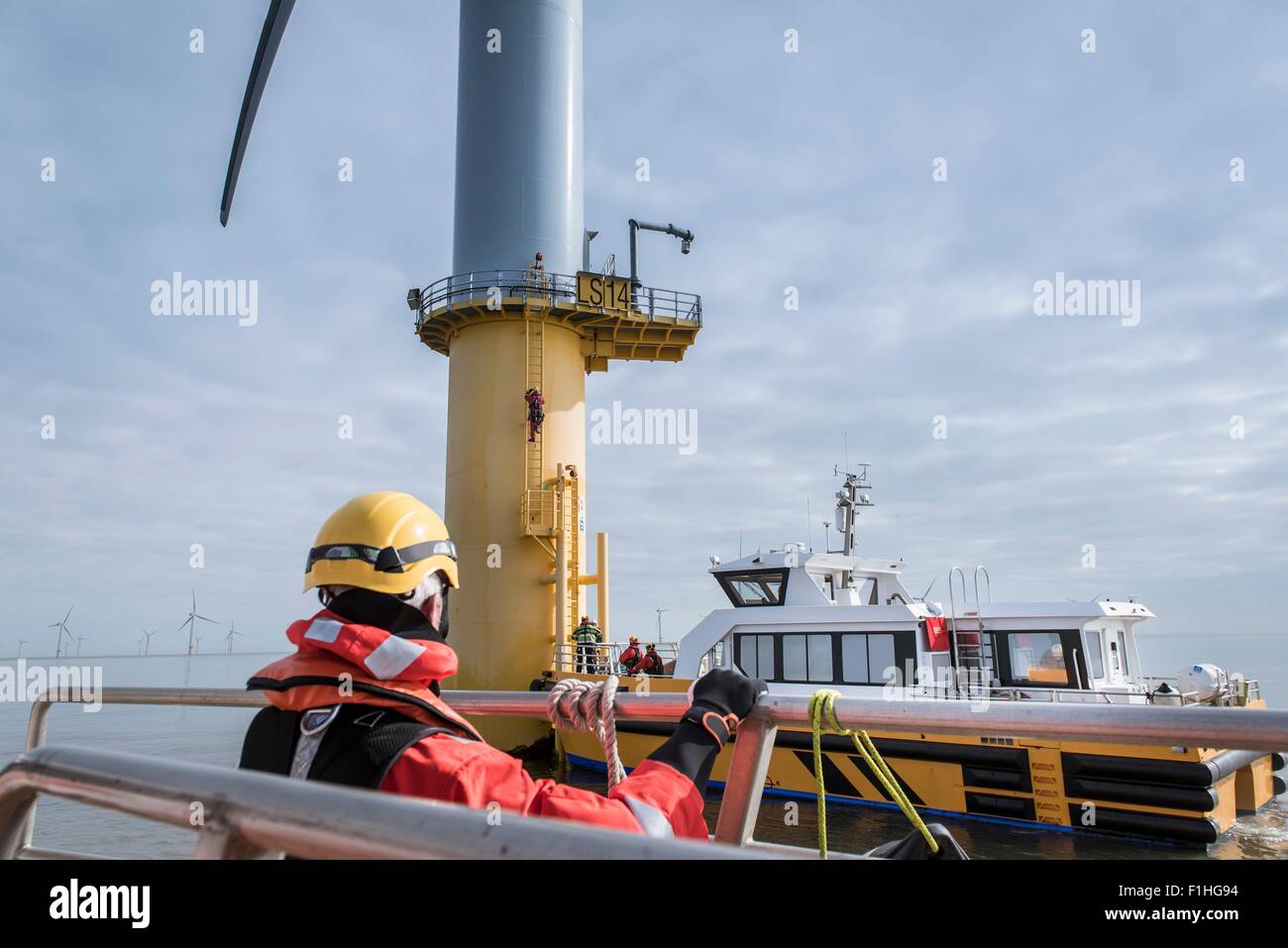 Service boat and wind turbine at offshore windfarm Stock Photo