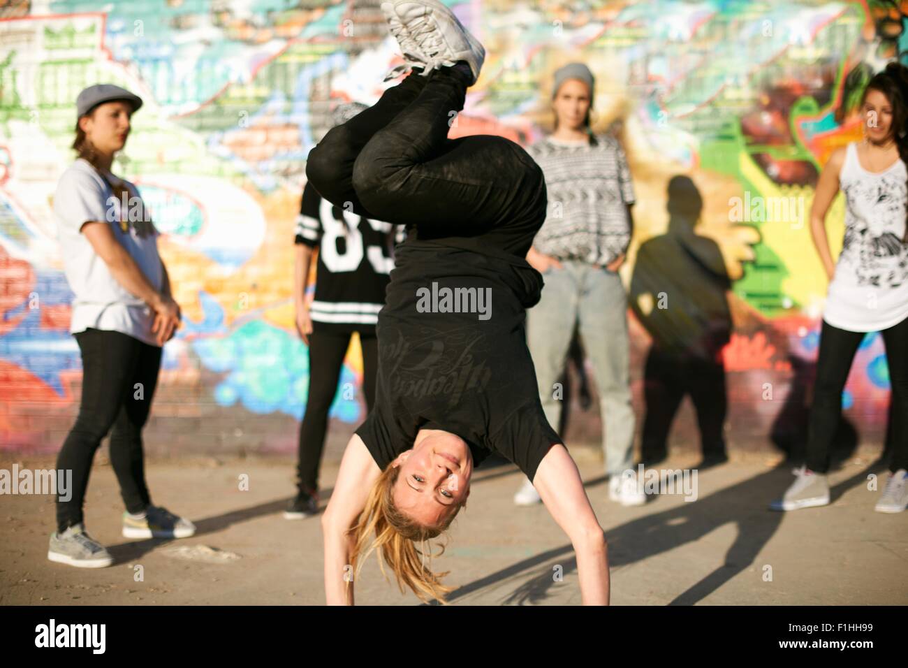 Young women in a breakdancing handstand freeze Stock Photo