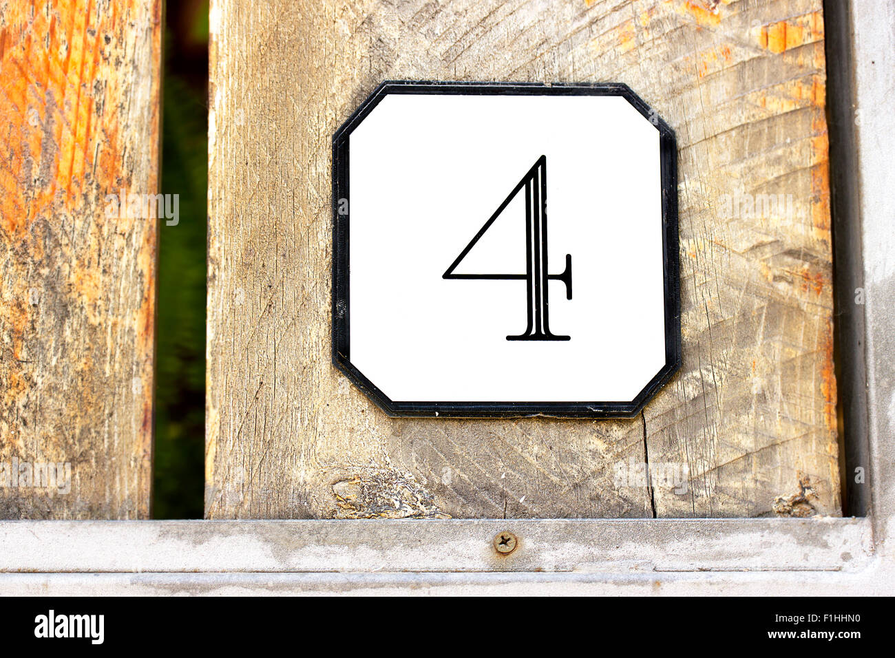Number 4 on textured wooden wall Stock Photo