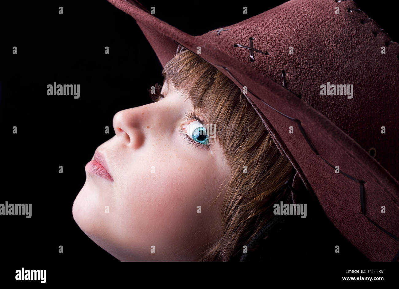 Cute freckle faced boy wearing a cowboy hat. Stock Photo