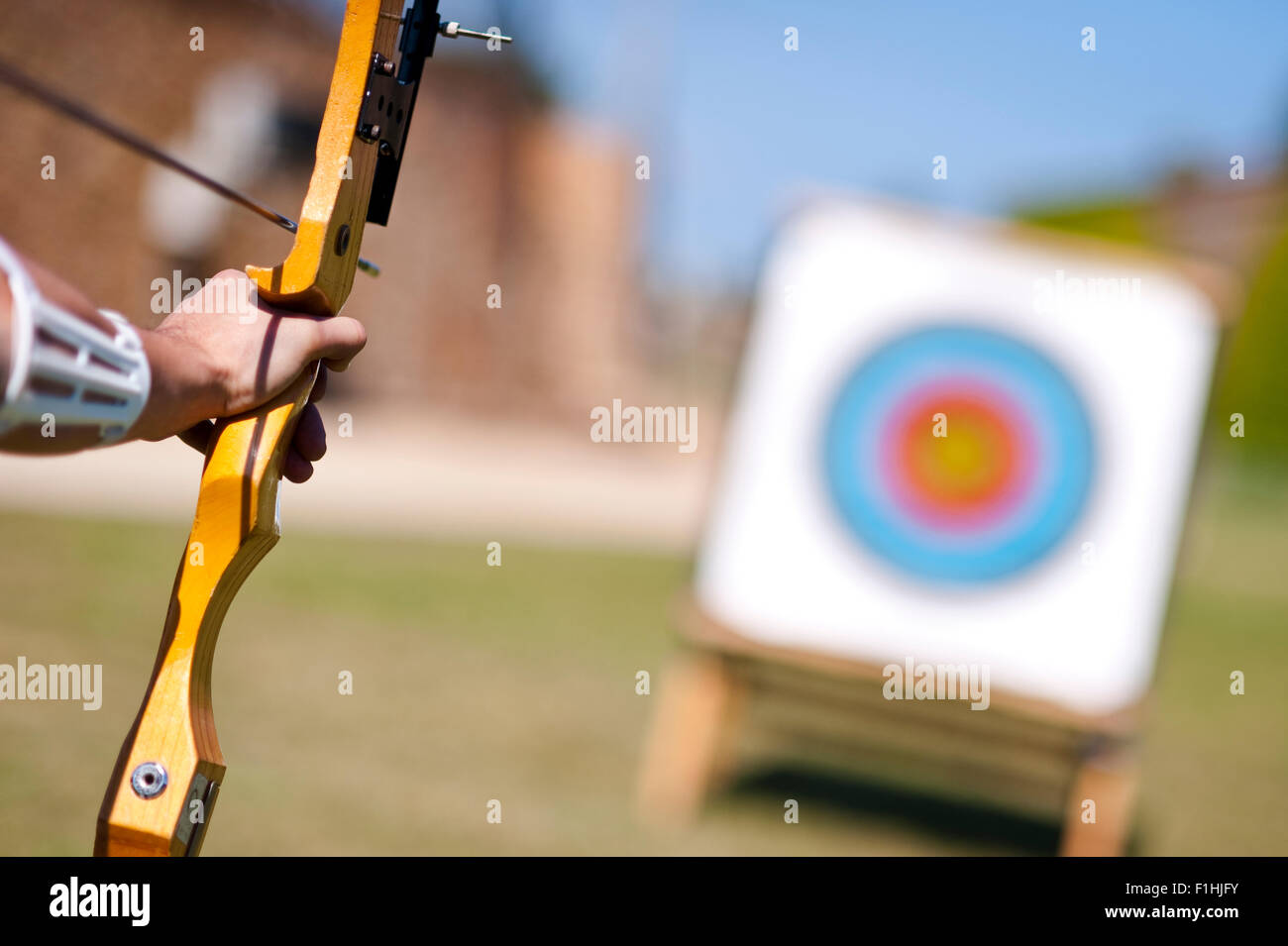 Archer holding a bow aiming at a target. Archery and target. Accuracy, concentration, focus, control, steady, competition, dedication and victory Stock Photo