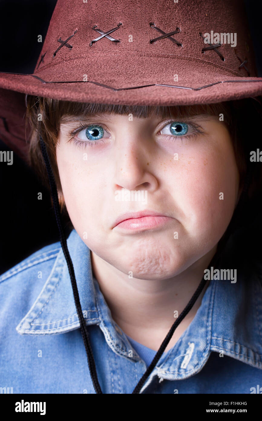 Cute freckle faced boy wearing a cowboy hat. Stock Photo