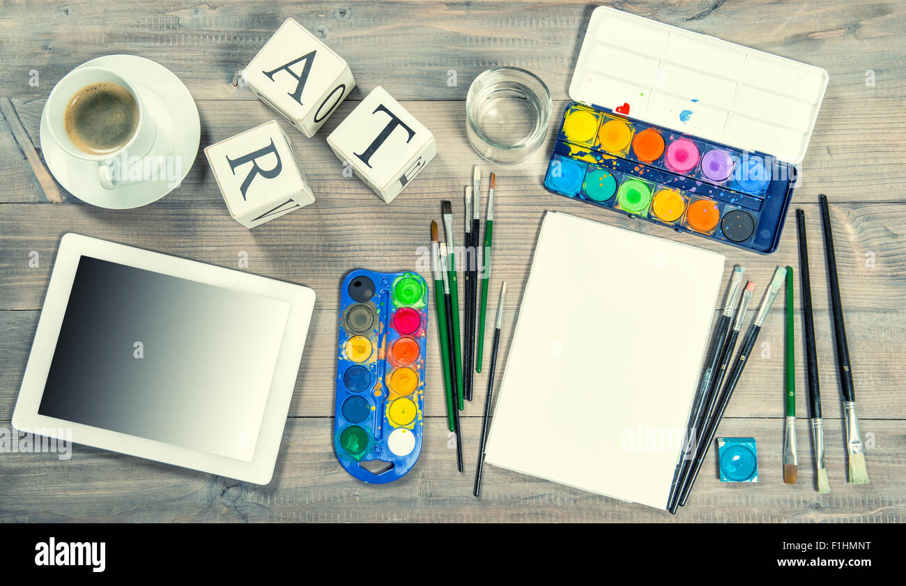 Artistic workplace mock up. Watercolor, brushes, paper, painting tools and items. Back to school concept. Stock Photo